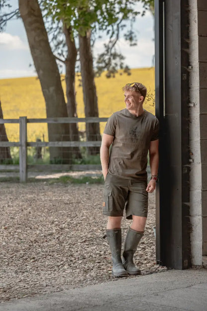 Man in outdoor gear showcasing New Forest Trail Shorts for forest trail adventures