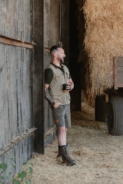 Man in outdoor attire wearing New Forest Trail Shorts for forest trail adventures
