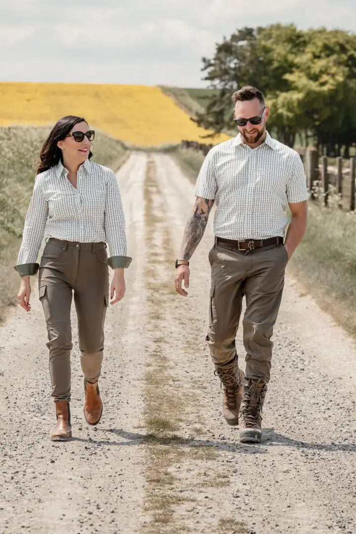 Couple walking on forest trail wearing New Forest Trail Trousers for outdoor adventures