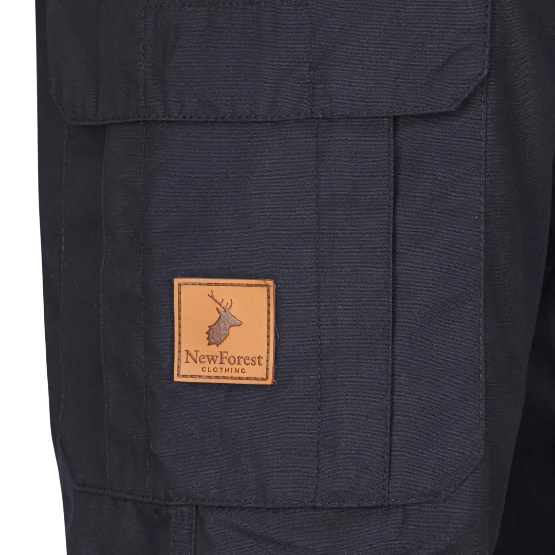Navy blue outdoor jacket with large pockets and leather patch for forest trail trousers