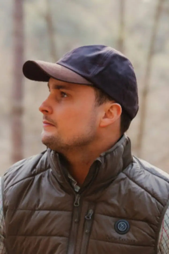 Man wearing a New Forest Wax Baseball Cap with a stylish vest and cap look