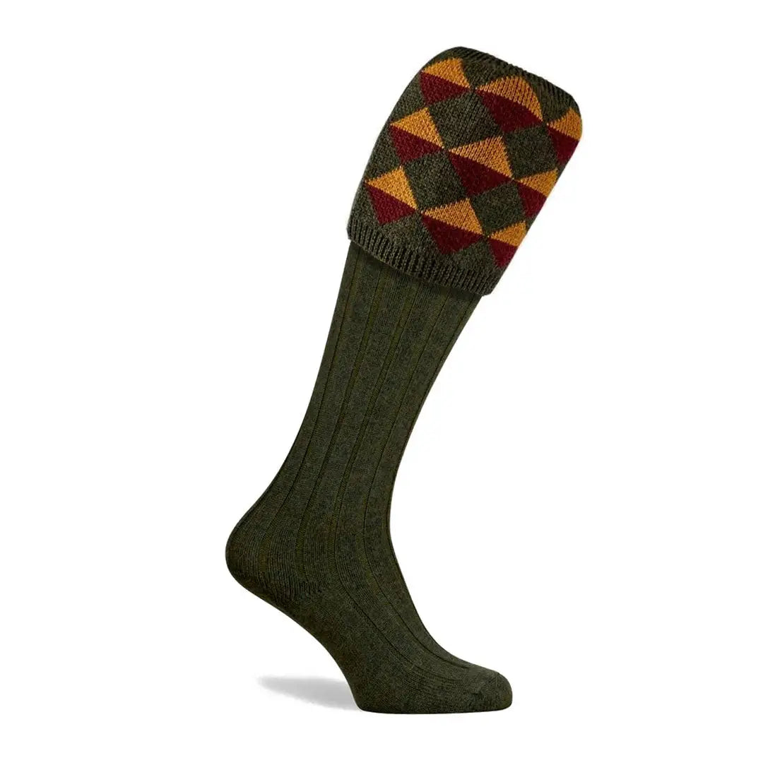 Pennine Grand Merion Shooting Sock in green argyle pattern made from cozy merino wool for country clothing and hunting