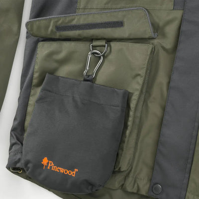 Green and gray jacket pocket with Pinewood Dog Sports Treat Bag for dog sports activities