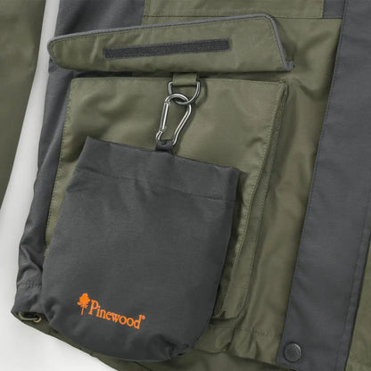 Green and gray jacket pocket with Pinewood Dog Sports Treat Bag for dog sports activities