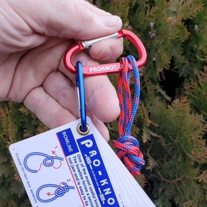 Hand holding red carabiner with blue red patterned rope in Pro Knot Tying Kit