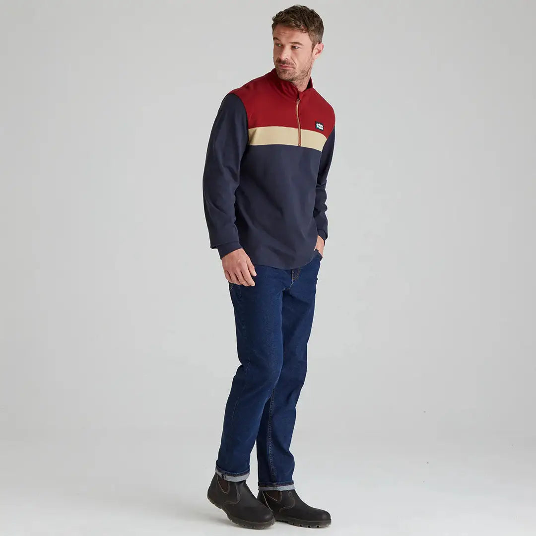 Man wearing Ridgeline Backslider Rugby Top with moisture-wicking finish and color-blocked design