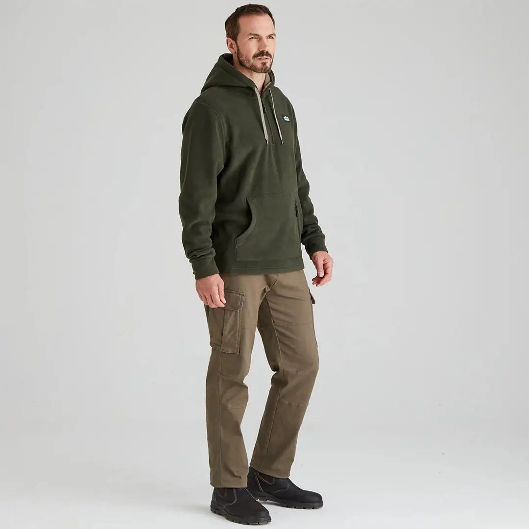 Man in green hoodie and cargo pants showcasing Ridgeline Ballistic Hooded Fleece offers superior warmth