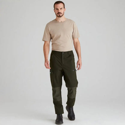 Man wearing green Ridgeline Cambrian Trousers and beige t-shirt perfect for all-day wear in worst weather