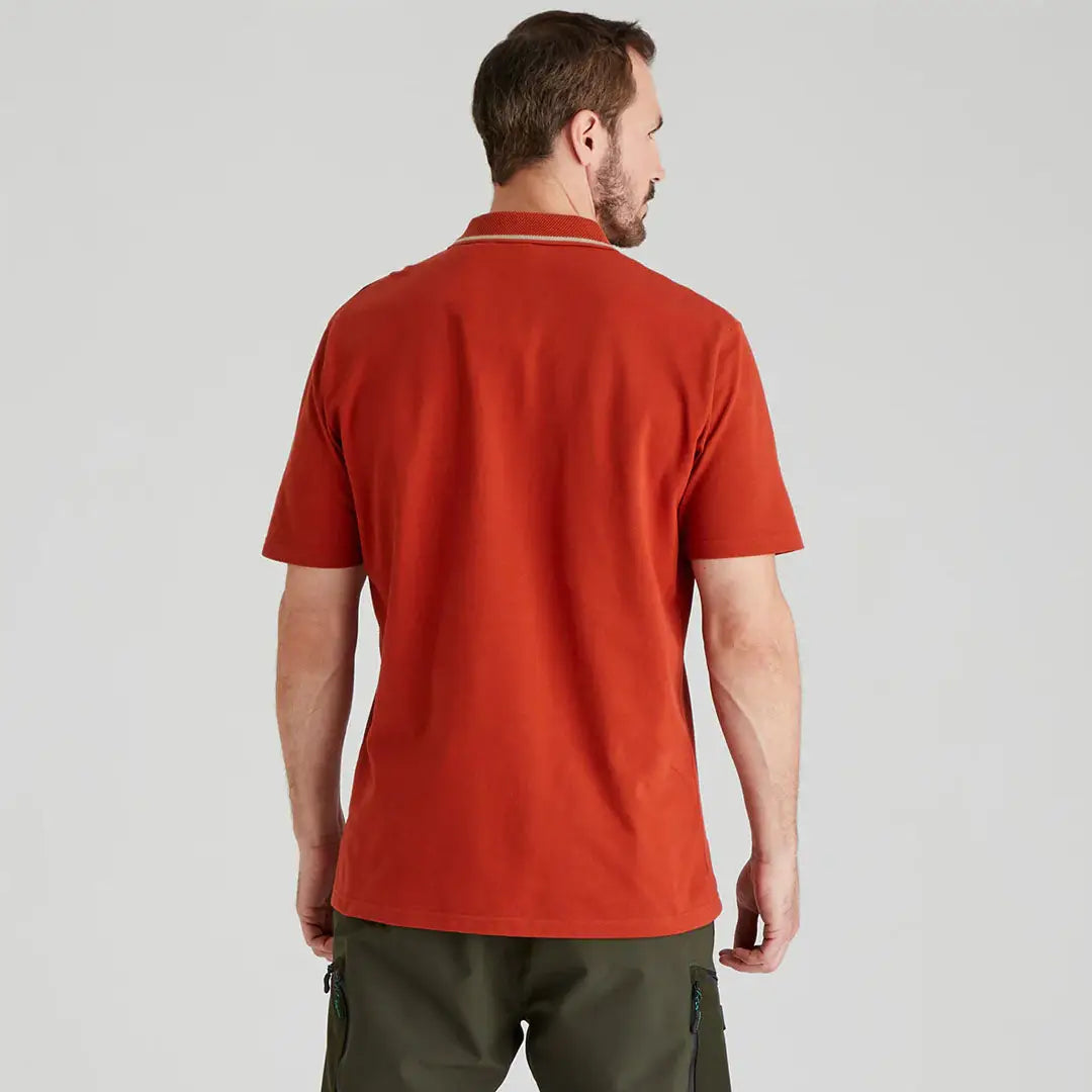Man wearing a rust-colored Ridgeline Kilworth Polo Top for a casual look