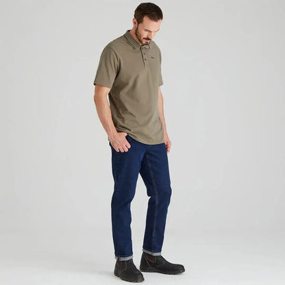 Man wearing Ridgeline Kilworth Polo Top, jeans, and boots for casual style