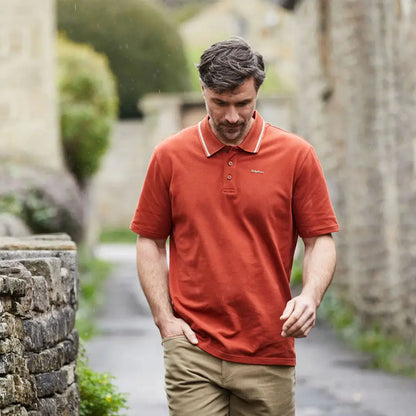 Man wearing Ridgeline Kilworth Polo Top in rust color for stylish kilworth polo look
