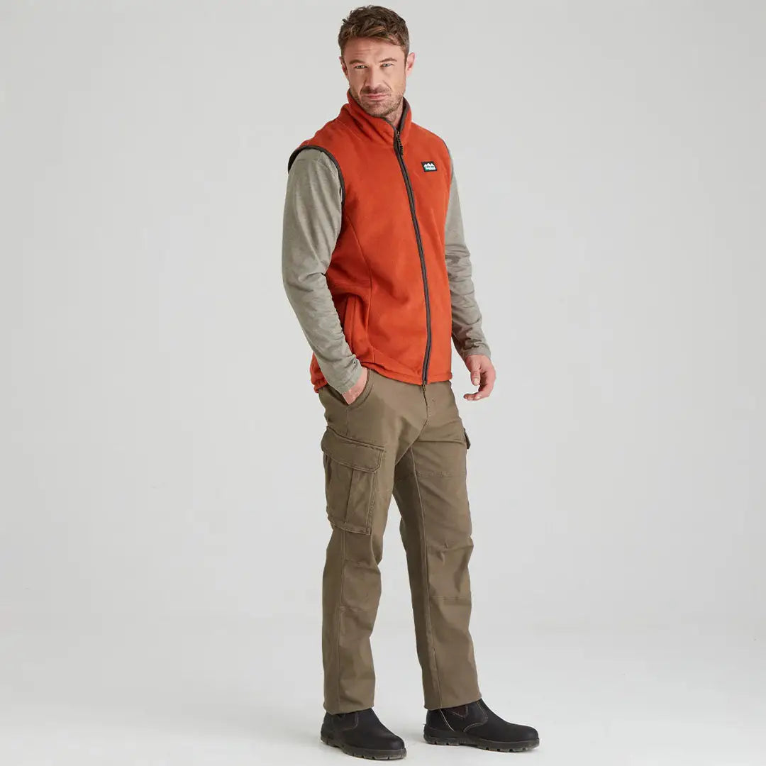 Man in orange vest and khaki pants wearing Ridgeline Kodiak Gilet outdoors