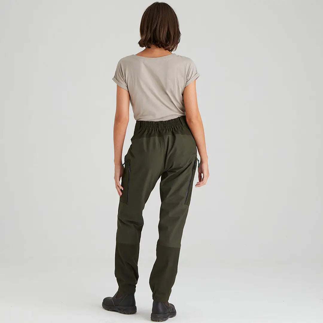 Woman in olive green Cambrian Trousers and beige t-shirt for all-day wear in worst weather