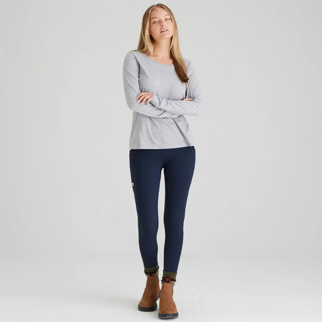Woman wearing Ridgeline Ladies Infinity Leggings in gray long-sleeved shirt and navy leggings