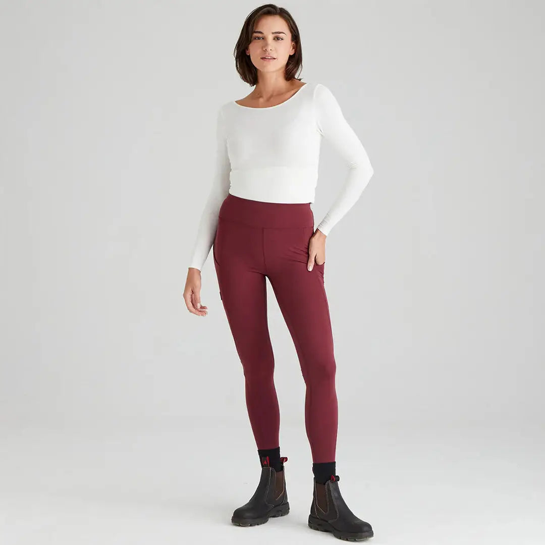 Woman in white top and burgundy infinity leggings, perfect athletic wear for country clothing
