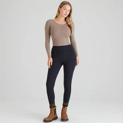 Woman wearing black infinity leggings and brown boots in country clothing style