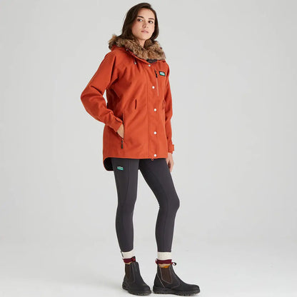 Woman wearing bright orange Ridgeline Ladies Monsoon Nordic Jacket in winter outdoor scene