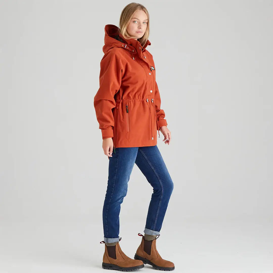 Woman wearing orange hooded jacket in Ridgeline Ladies Monsoon Nordic Smock