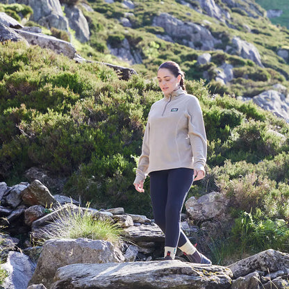 Woman hiking in outdoor apparel wearing Ridgeline Ladies Narvik Fleece made of highly functional polyester fleece
