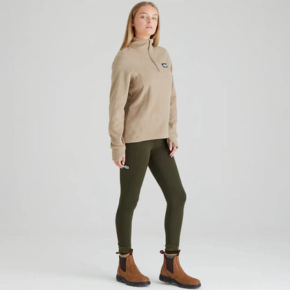 Woman in beige Ridgeline Ladies Narvik Fleece with green leggings and brown boots