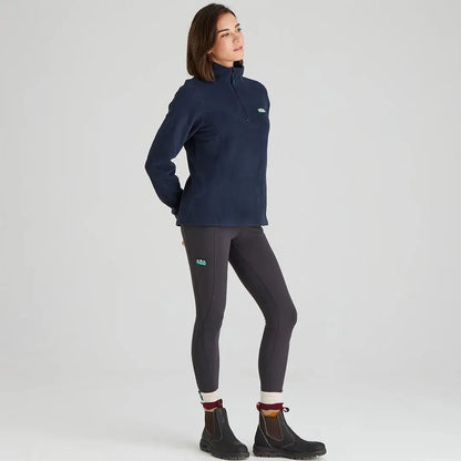 Woman in navy Ridgeline Ladies Narvik Fleece with gray leggings and black boots