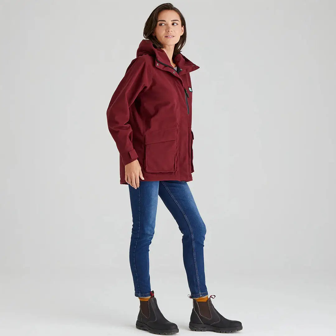 Burgundy Rhea Jacket field coat with blue jeans and black boots for a stylish, hard-working look