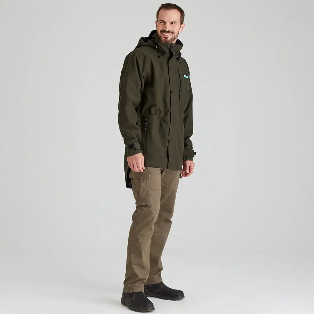 Man wearing olive green Ridgeline Mens Monsoon Classic Waterproof Jacket outdoors