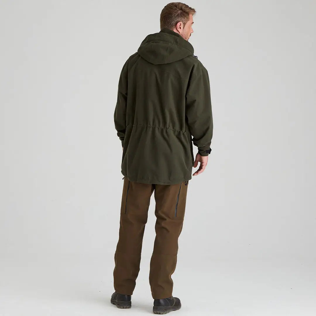 Man in green hooded Ridgeline Torrent III Jacket and brown pants, perfect for country clothing