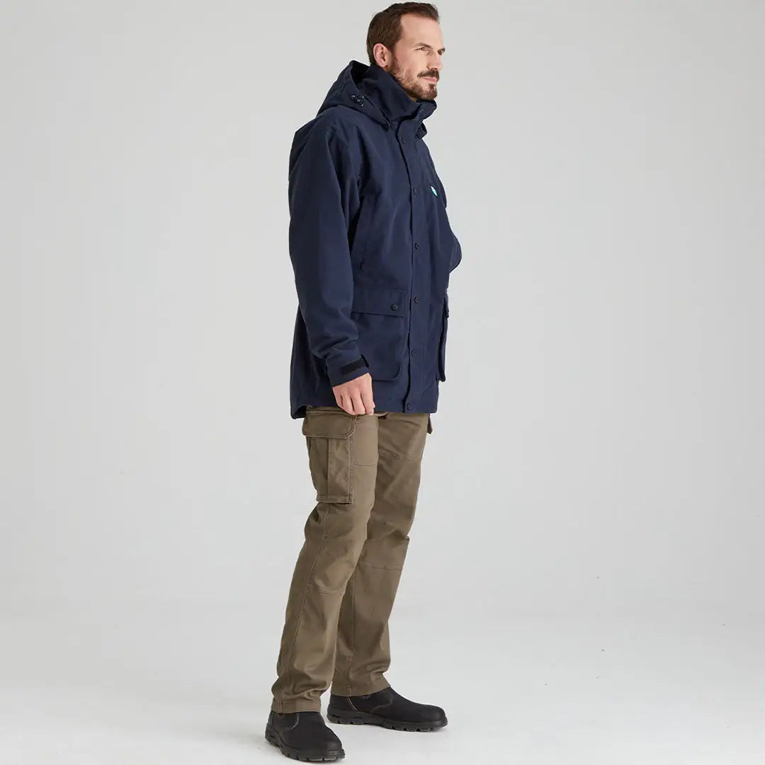 Man in navy hooded parka and olive cargo pants wearing Ridgeline Torrents III jacket