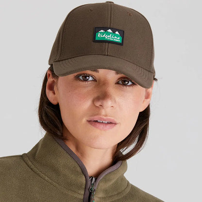 Woman wearing Ridgeline Monsoon Classic Cap and matching fleece jacket outdoors