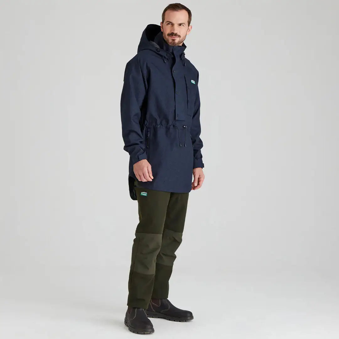 Man wearing a navy Ridgeline Monsoon Light Smock and green pants outdoors