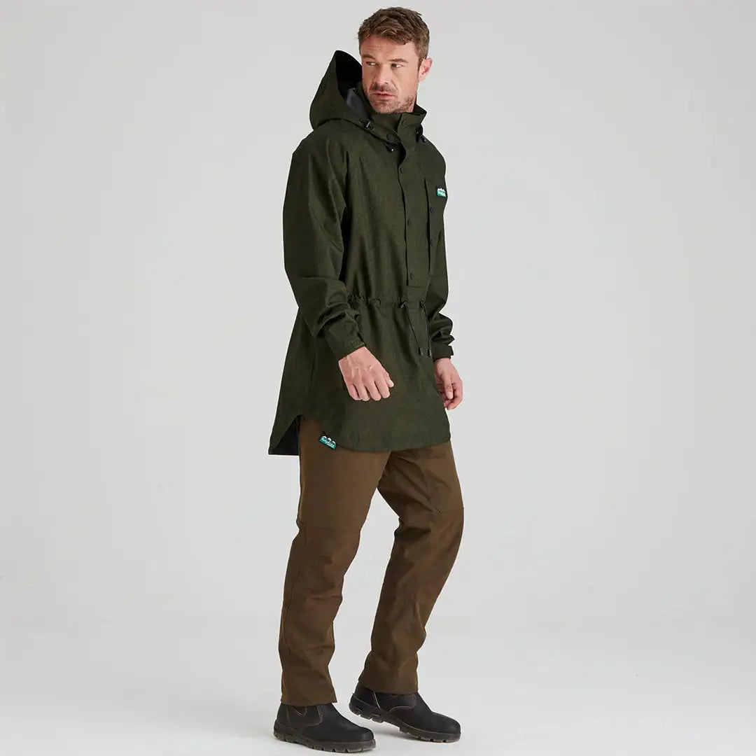 Man wearing ridgeline monsoon light green hooded smock and brown pants outdoors
