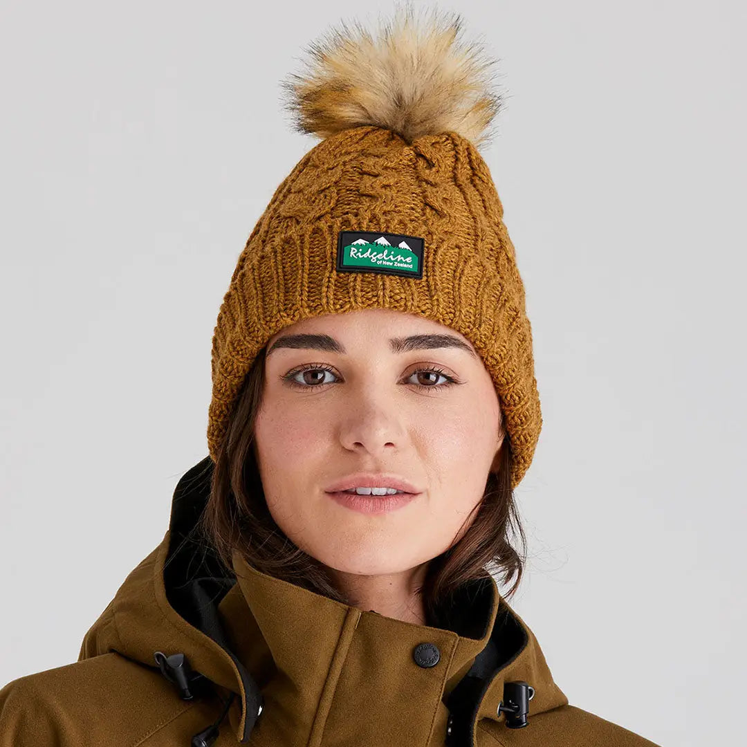 Woman wearing Ridgeline Nordic Fleck Bobble Hat with faux fur pom-pom for cozy style