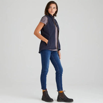 Woman in Ridgeline Womens Kodiak Gilet with navy vest, jeans, and boots