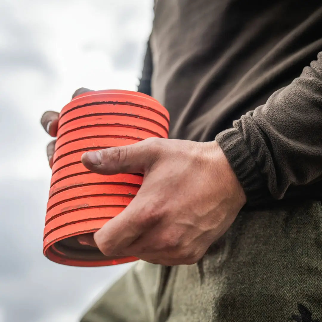 Stack of orange clay targets for Seeland Benjamin Half Zip Fleece shooting gear