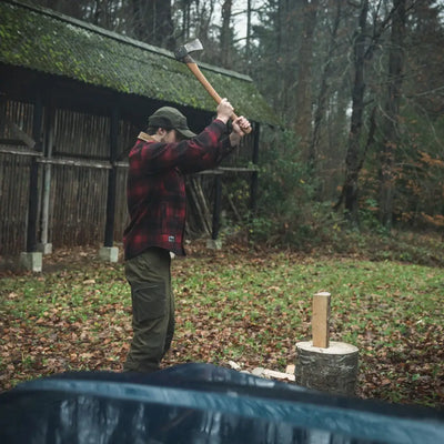 Man wielding axe wearing Seeland Canada Yukon Shirt in outdoor Yukon scene