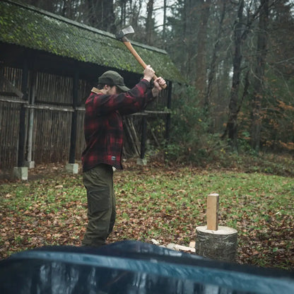 Man wielding axe wearing Seeland Canada Yukon Shirt in outdoor Yukon scene