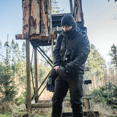 Hunter in cold-weather gear wearing Seeland Celsius Heat Gloves for warmth in winter