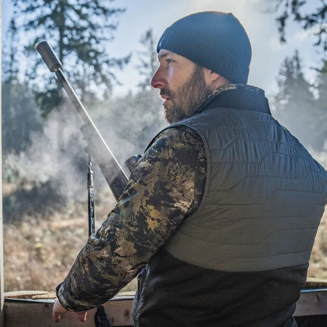 Man holding rifle wearing Seeland Celsius Heat Liner Waistcoat for warmth in the cold