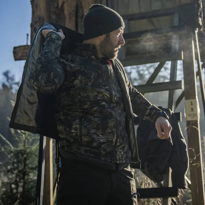 Man in camouflage jacket wearing Seeland Celsius Heat Liner Waistcoat for warmth
