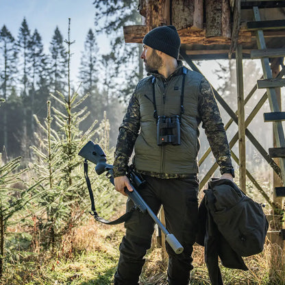 Hunter with rifle and binoculars wearing Seeland Celsius Heat Liner Waistcoat for warmth