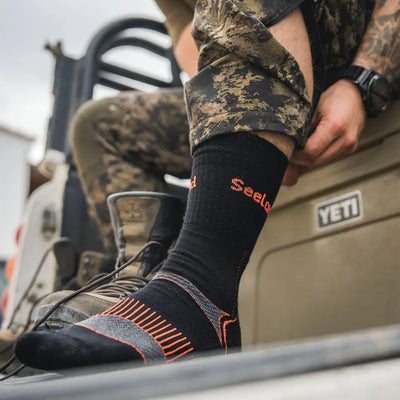 Black sock with orange stripes from Seeland Field Coolmax Sock 2 Pack, perfect for hunting