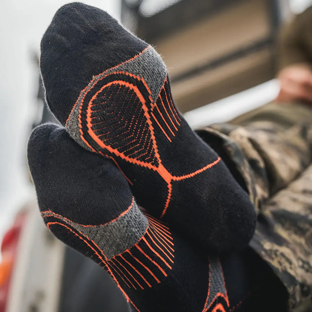 Black field Coolmax socks with orange accents from Seeland, perfect for hunting trips