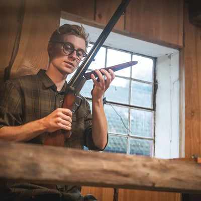 Man wearing Seeland Glen Flannel Shirt holding a shotgun in outdoor setting