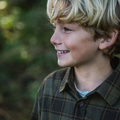 Smiling blond boy wearing Seeland Glen Junior Flannel Shirt in plaid style