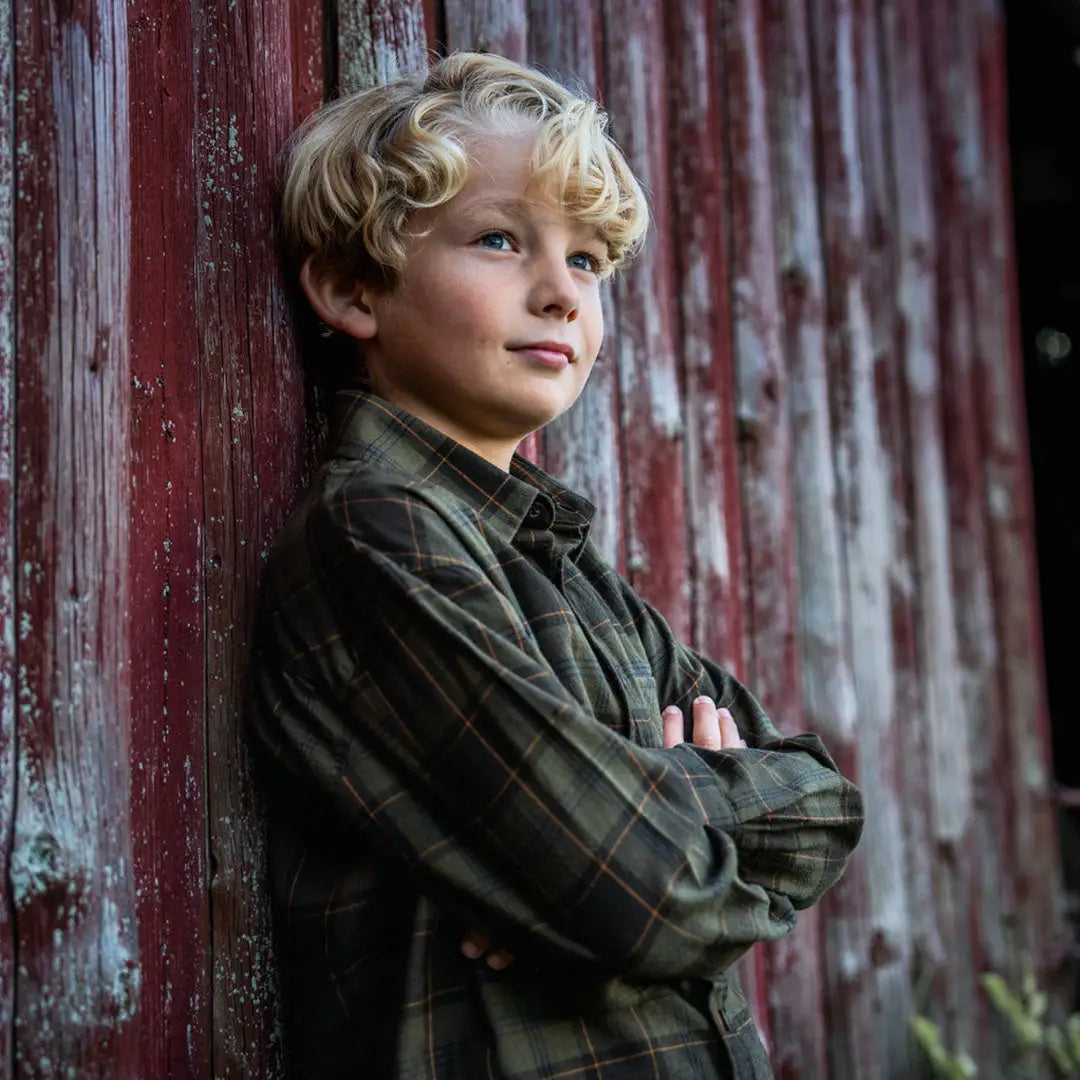 Blond boy wearing Seeland Glen Junior Flannel Shirt in a plaid style for kids