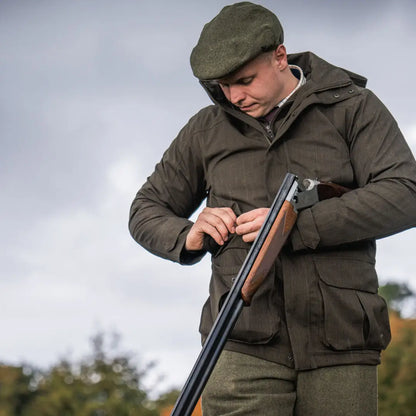 Man in hunting attire with shotgun wearing Seeland Highpoint Jacket for country hunting