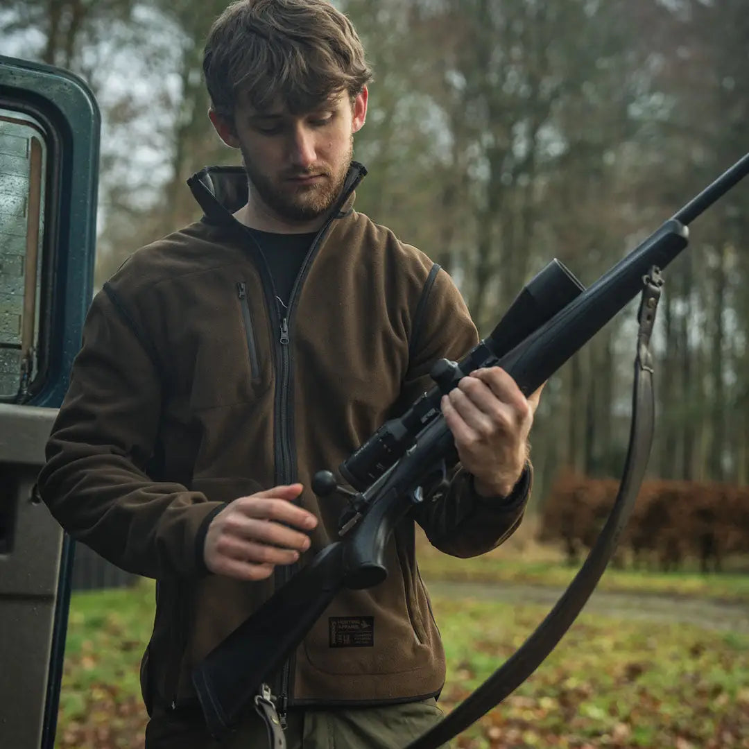 Black hunting rifle with scope on Seeland Rogue Solid Reversible Fleece Jacket