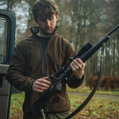 Black hunting rifle with scope on Seeland Rogue Solid Reversible Fleece Jacket