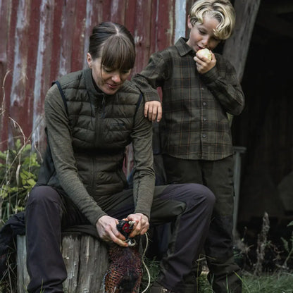 Woman plucking pheasant in country clothing wearing Seeland Therma Womens Waistcoat hunting outdoors